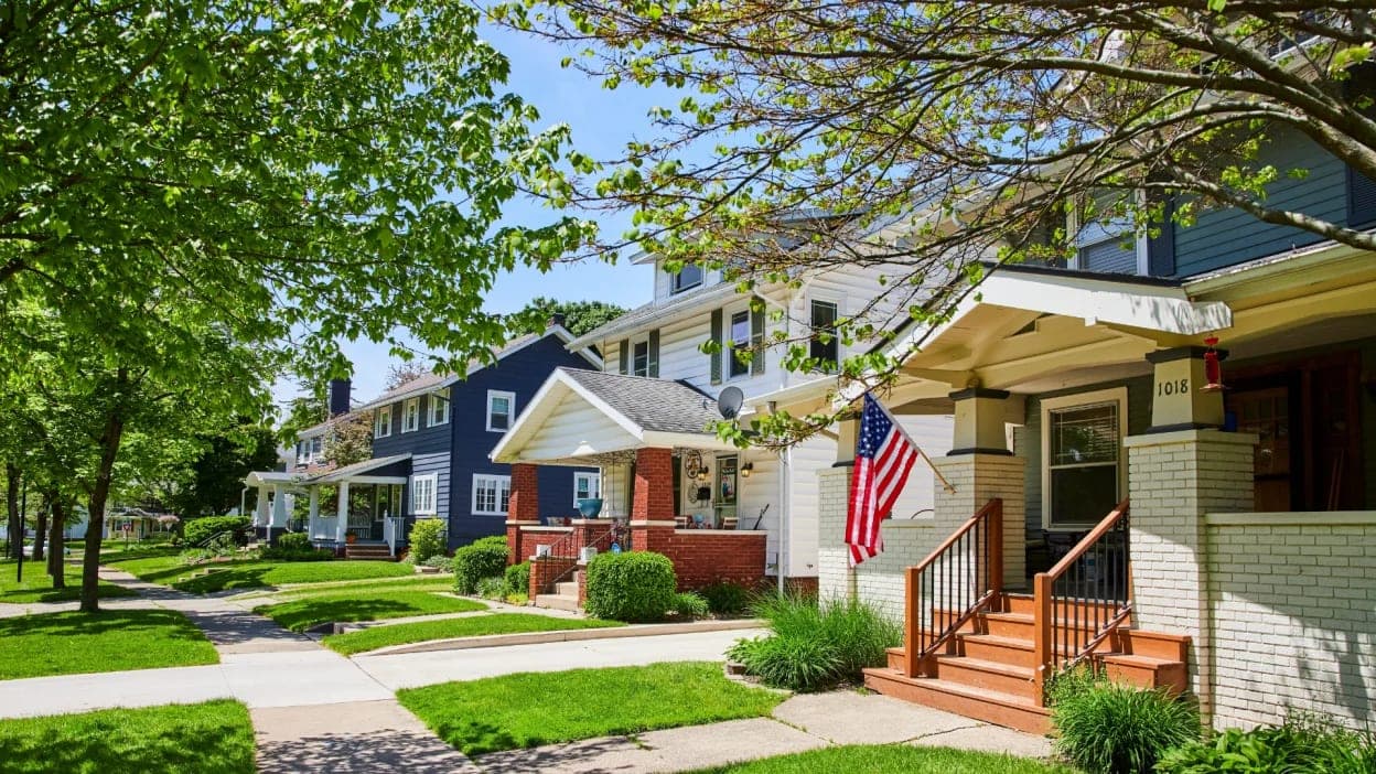 Picture of house in neighborhood with American flag hanging